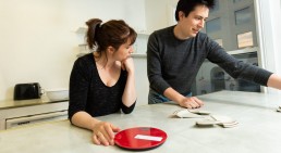 Man and woman working on puzzle in escape room