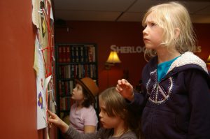 Children working on puzzle in escape room