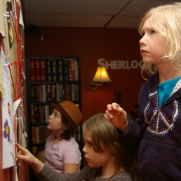 Children working on puzzle in escape room